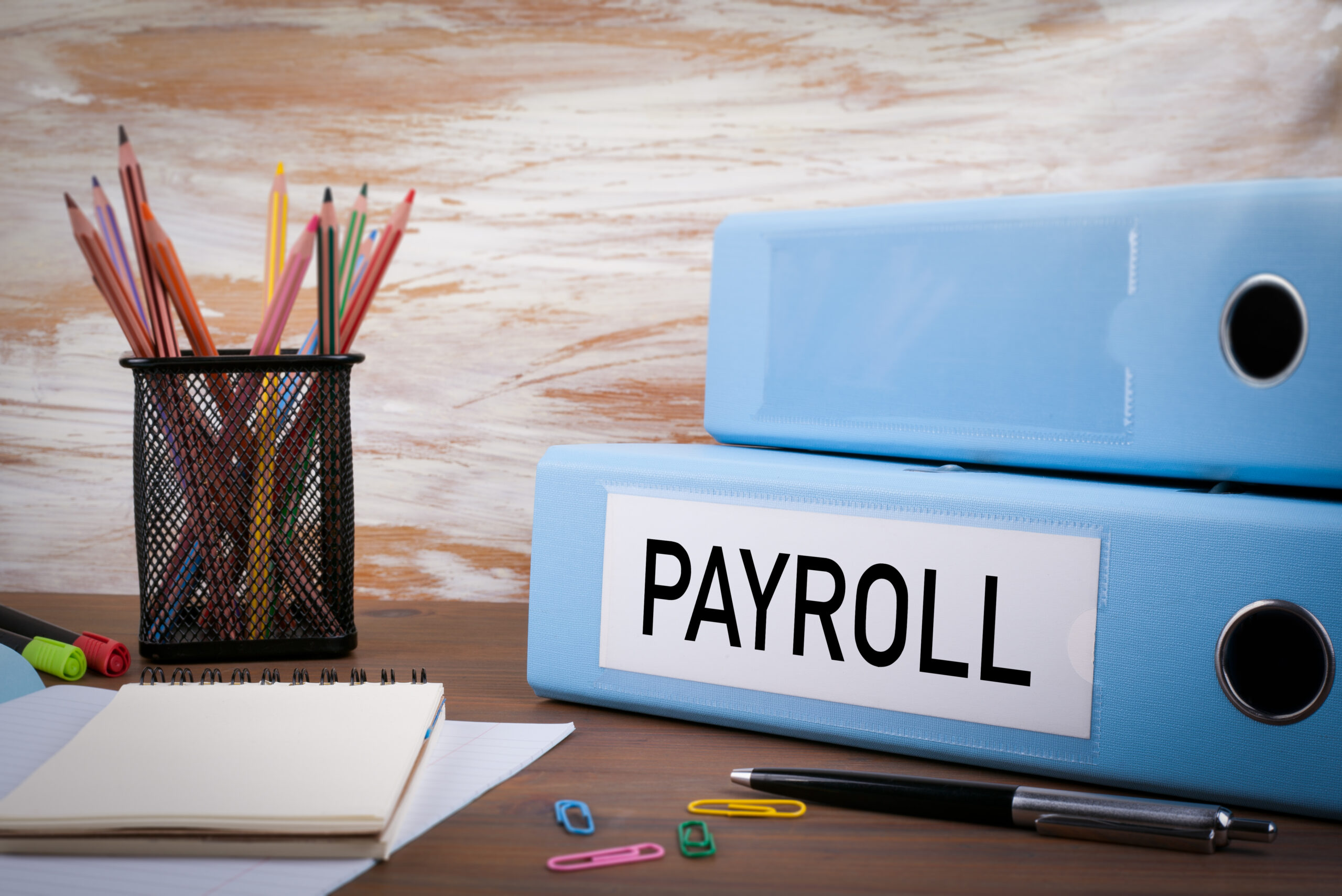 Payroll,,Office,Binder,On,Wooden,Desk.,On,The,Table,Colored